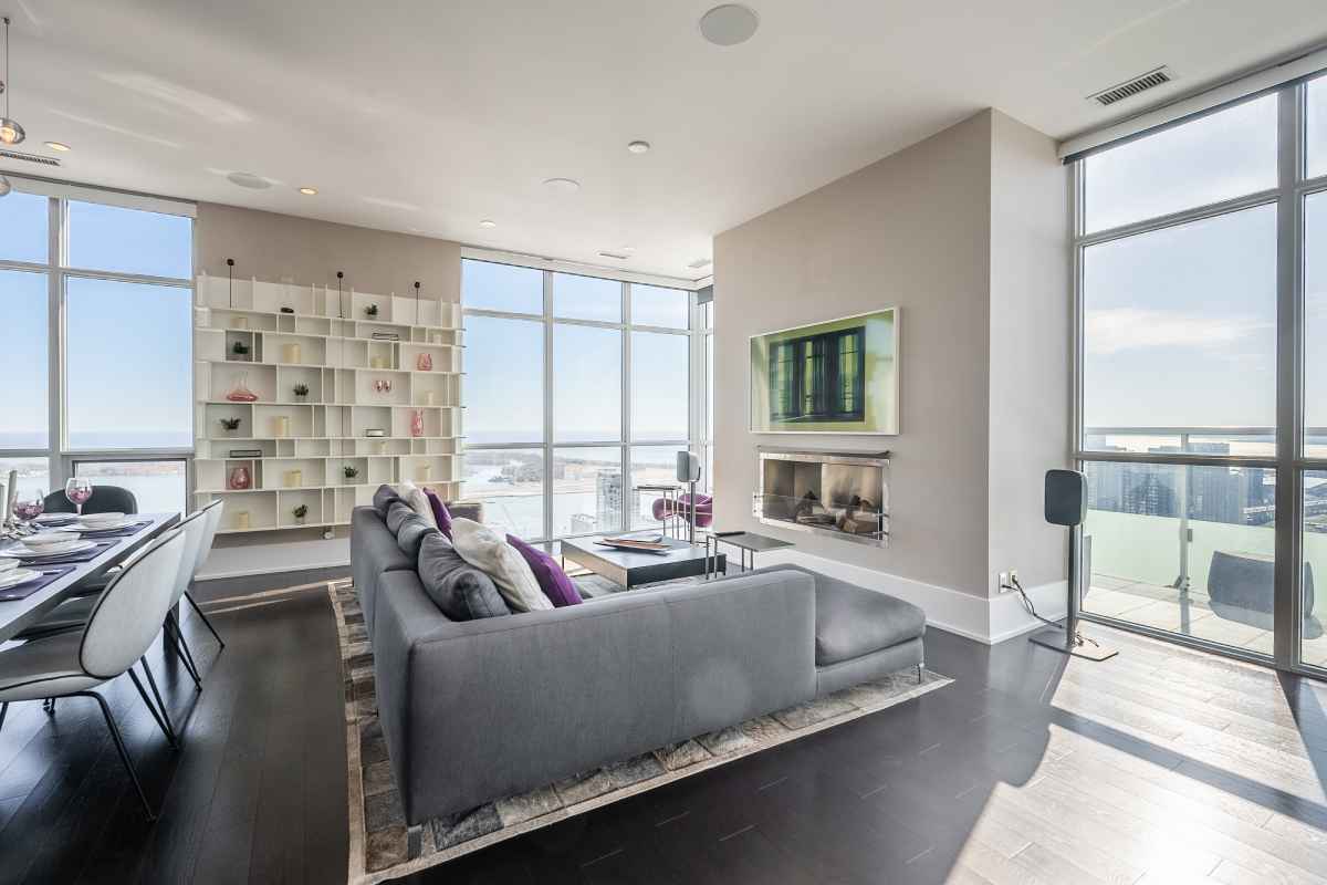 a living room filled with furniture and large windows